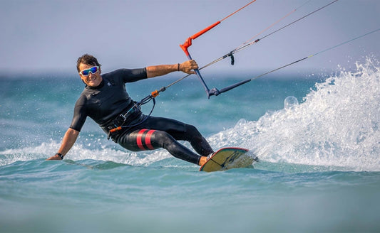 Kitesurfer riding in spray wearing Ocean polarized sunglasses