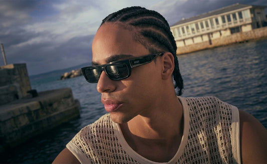 Rider at a harbour wall wearing Ocean black rectangular sunglasses